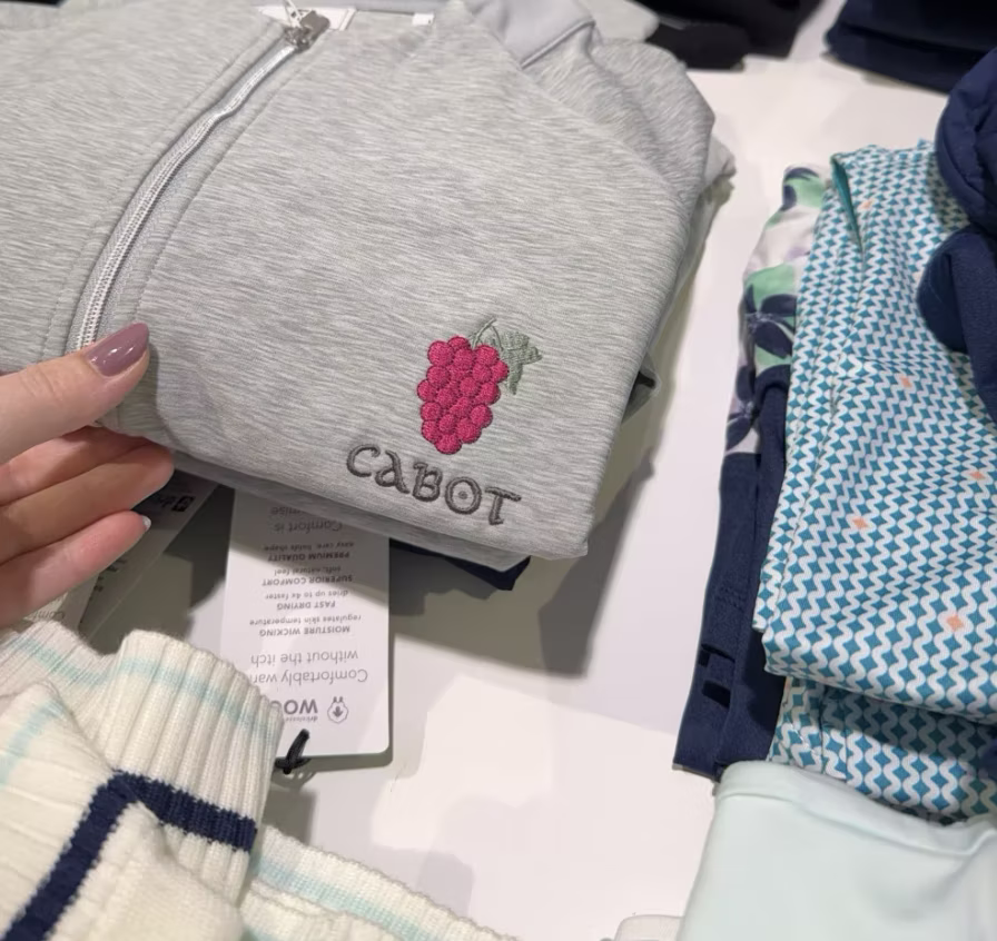 Hat with embroidery thread running brighter and pinker than the Cabot brand colours